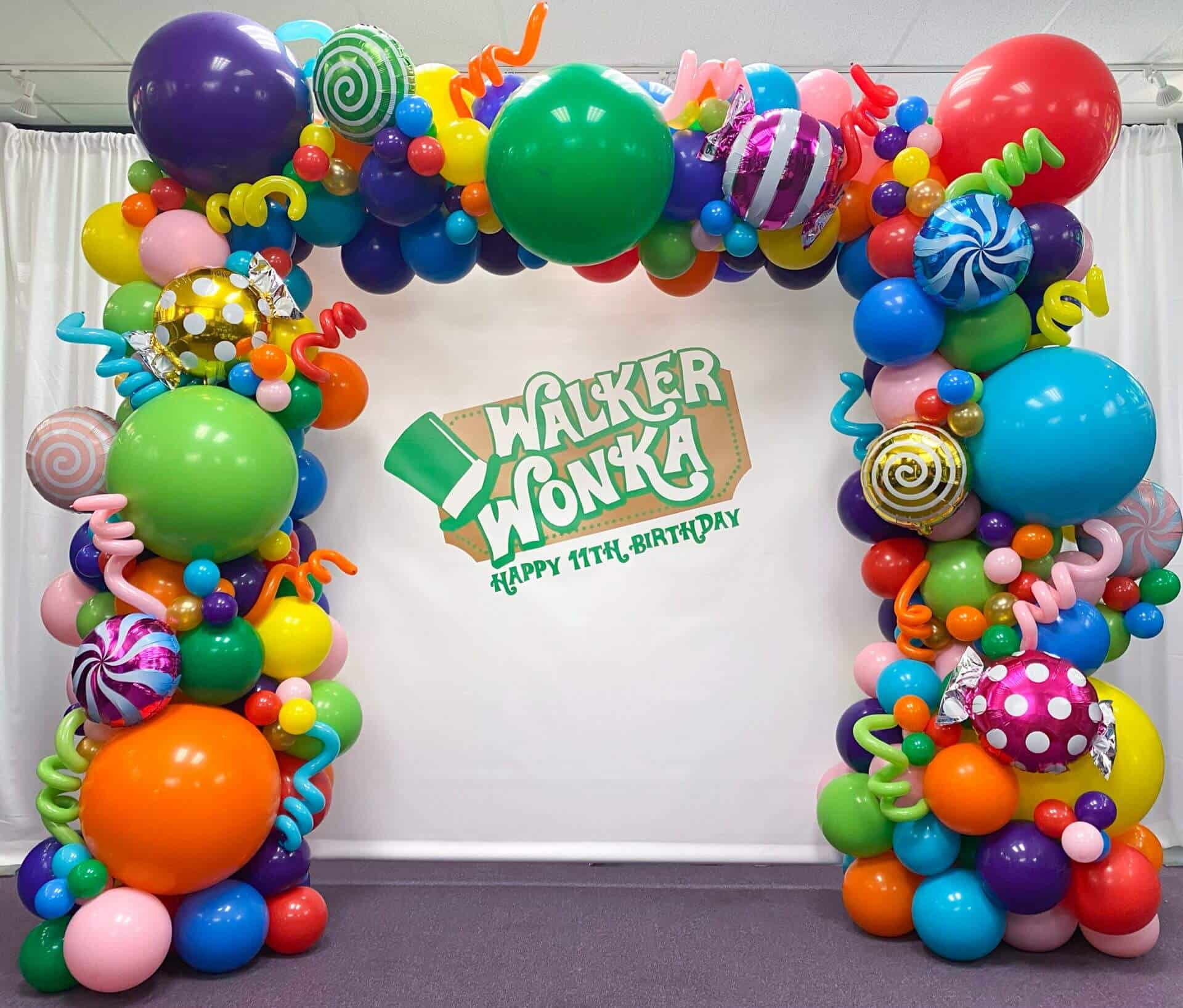 Willy Wonka Balloon Arch with Mylar Candy Balloons and Custom Logo Backdrop
