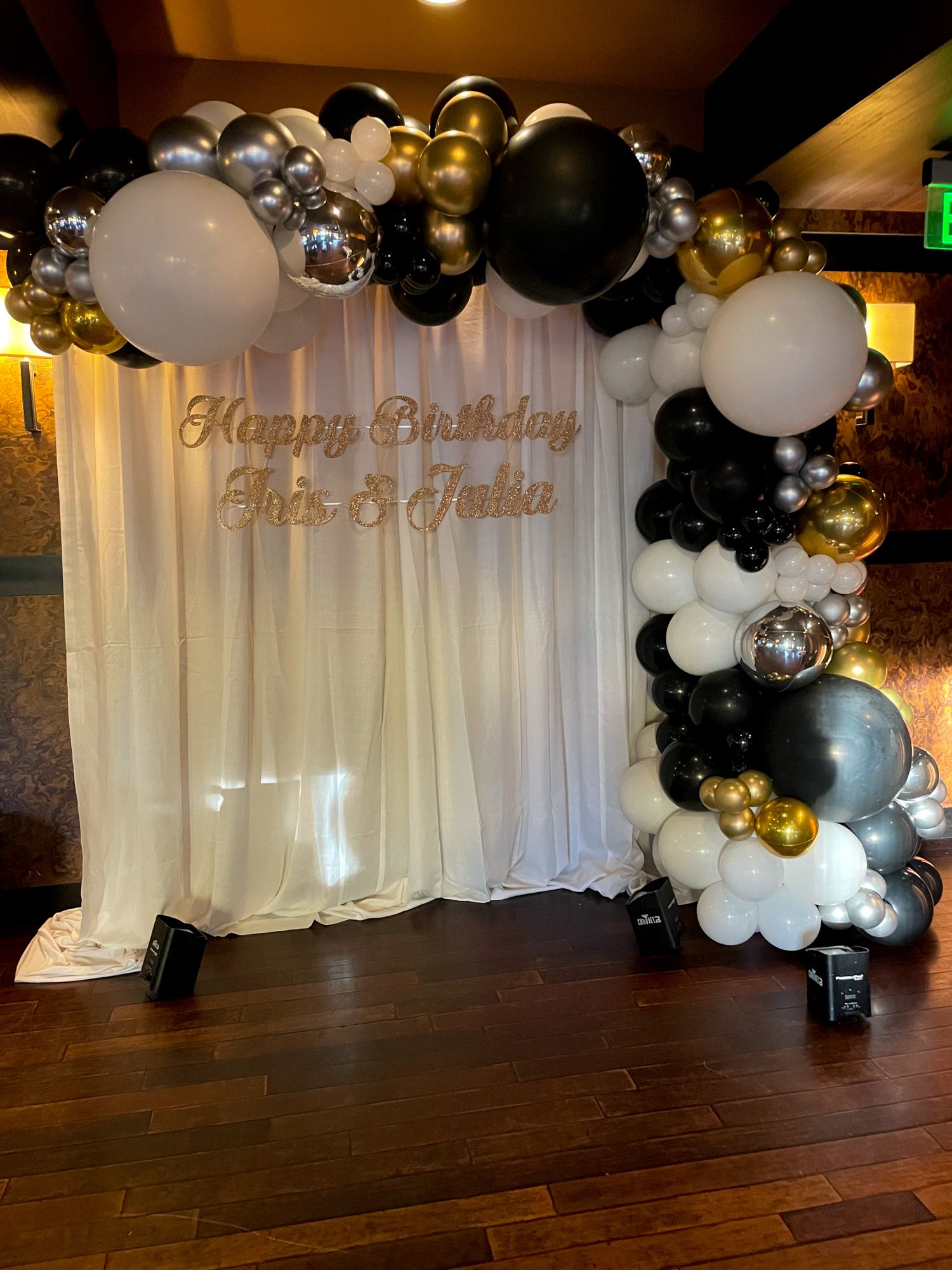 Beautiful Black and White Organic Balloon Arch Metallic Silver and Gold Accent Over Pipe and Drape Custom Hand Cut Signage for 18th Birthday Party