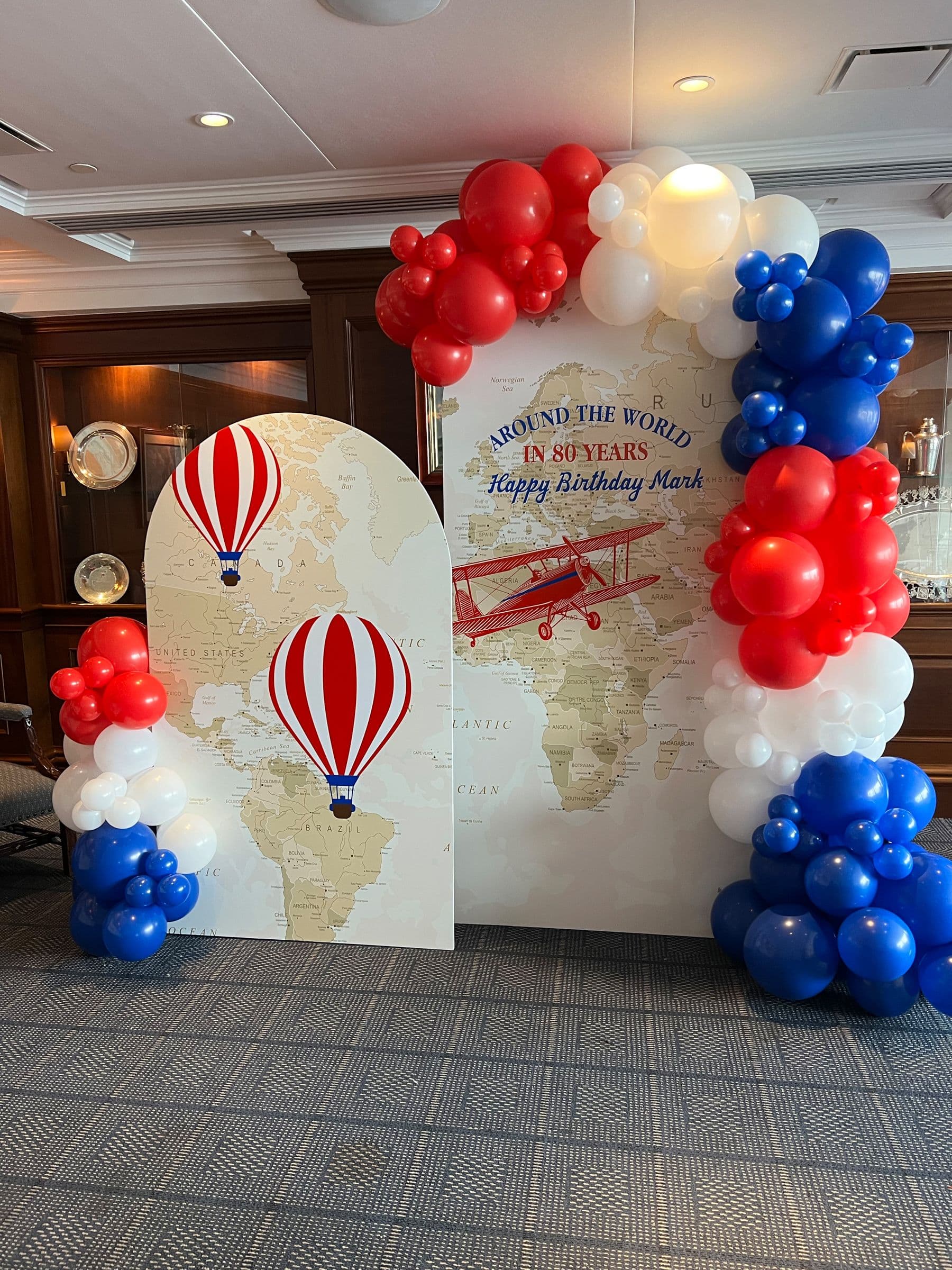 Travel Themed Photo Backdrop with Custom Chiara Arches and Organic Balloon Garland