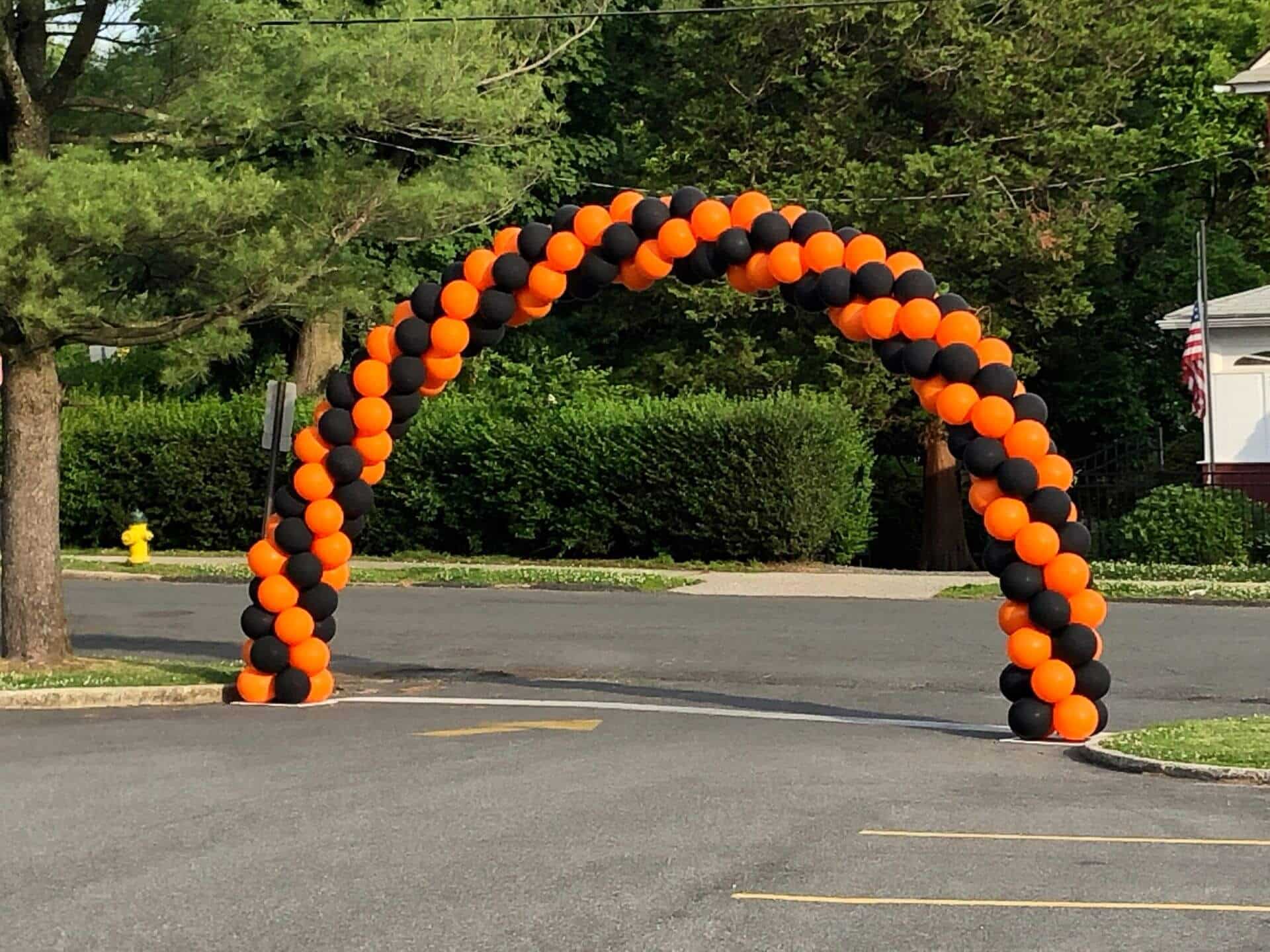 Orange and Black Balloon Arch for Drive By Graduation