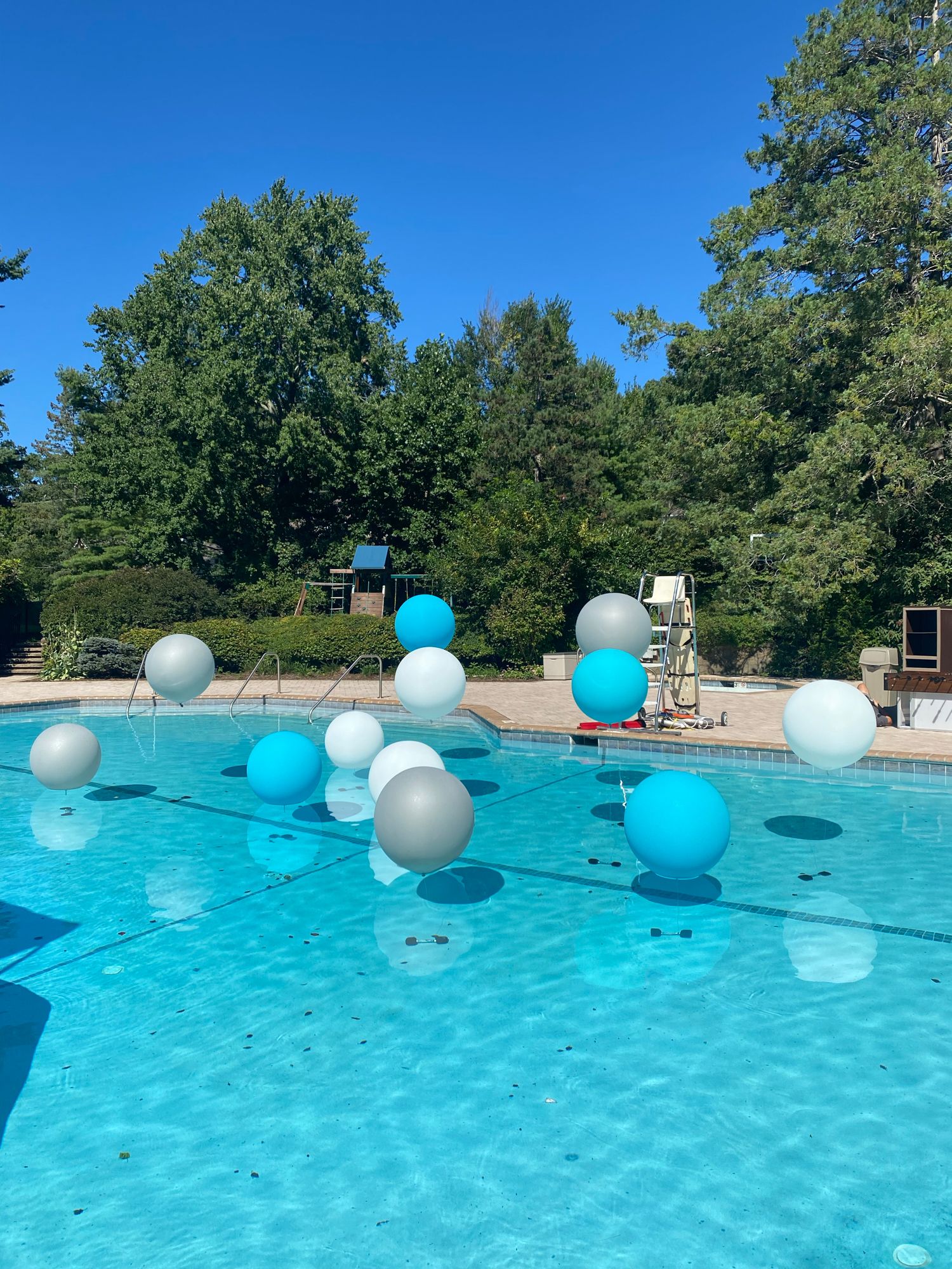 Amazing Pool Treatment with Large White, Silver and Caribbean Blue Balloons for Outdoor Bat Mitzvah Decor