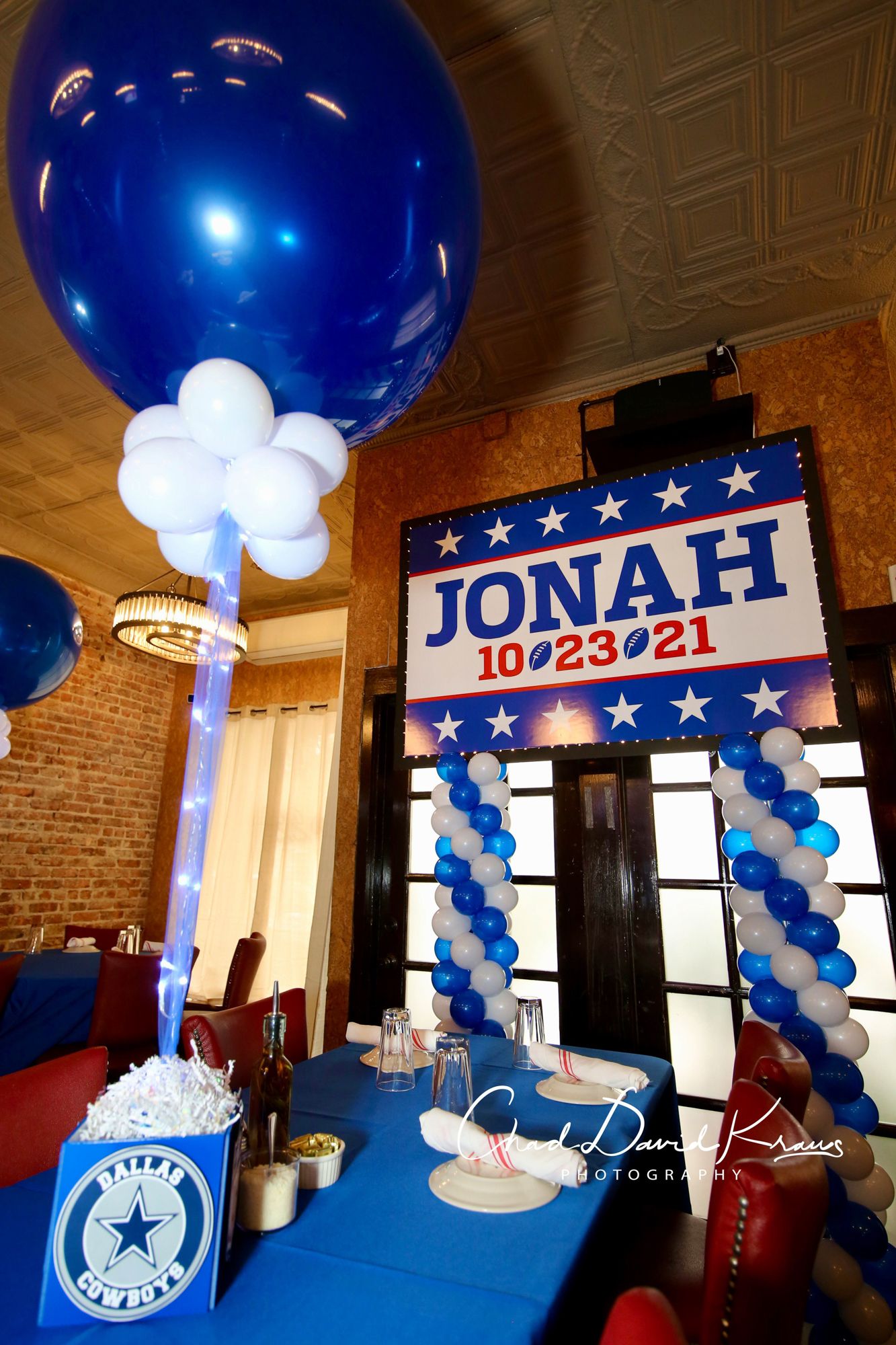 Football Inspired LED Custom Printed Backdrop Over Balloon Columns and Large Balloon Centerpiece on a Custom Football Themed Logo Cube for Bar Mitzvah Decor