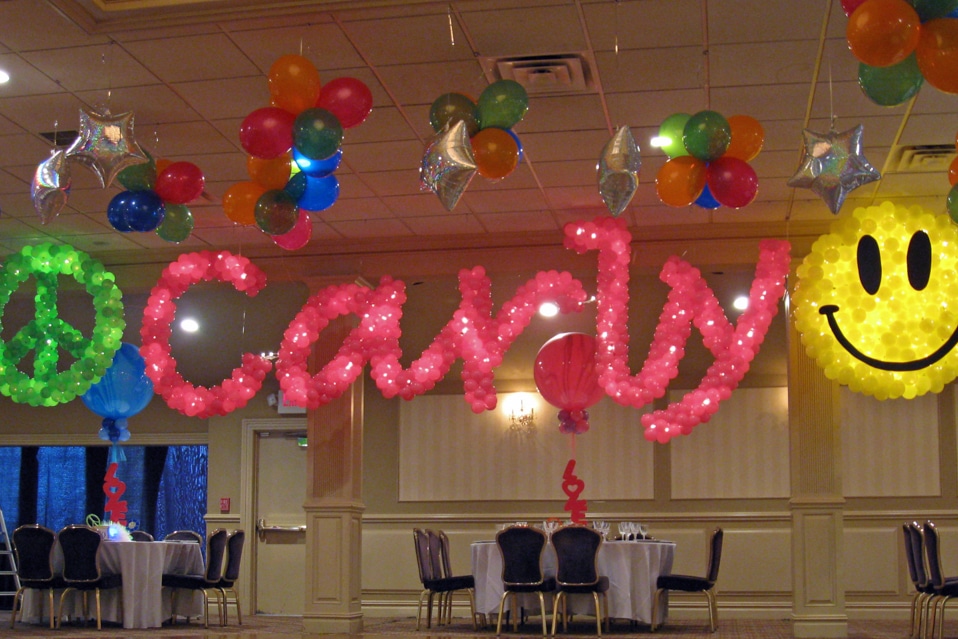 Pink Name in Balloons with Smiley Face and Peace Sign Balloon Sculpture
