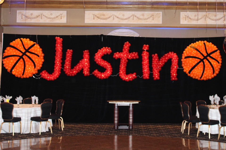 Basketball Balloon Sculptures with Name in Balloons on Black Curtain Backdrop