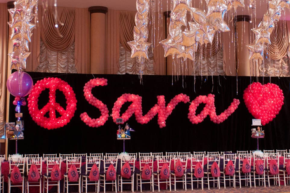Peace Sign, Heart and Name in Balloons Sculpture on Black Curtain Backdrop