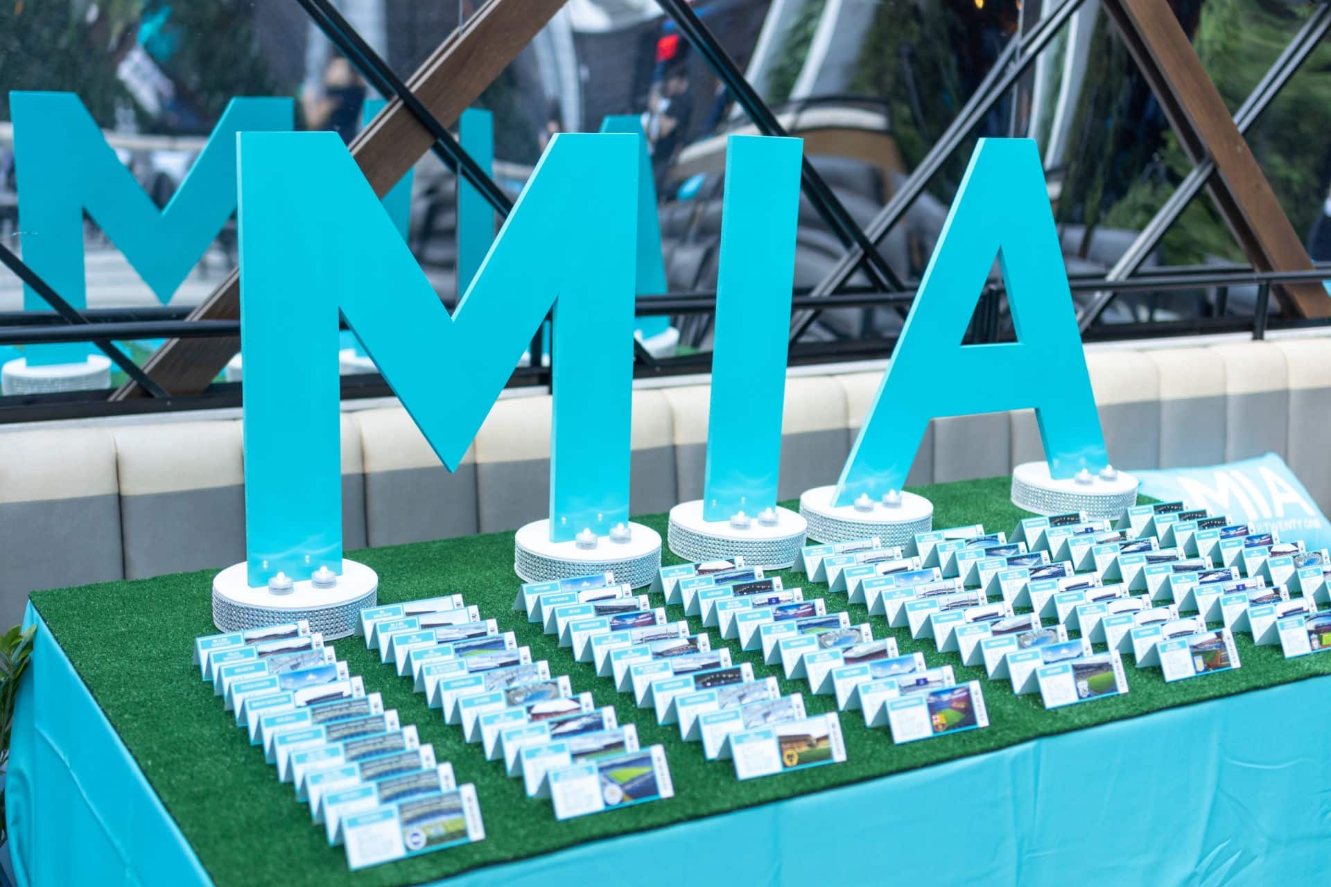 Fold Over Soccer Tickets Place Cards with Cut Out Turquoise Glitter Letters as a Seating Card Display for Bat Mitzvah