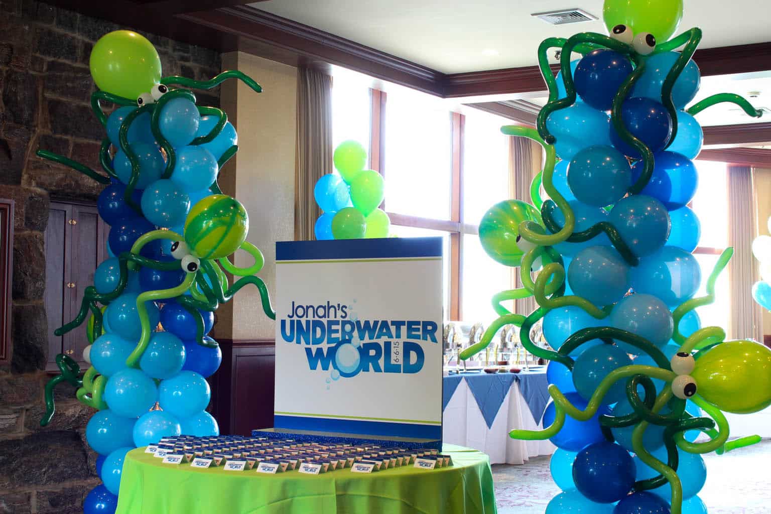 Underwater Themed Seating Card Display with Custom Logo and Octopus Balloon Columns