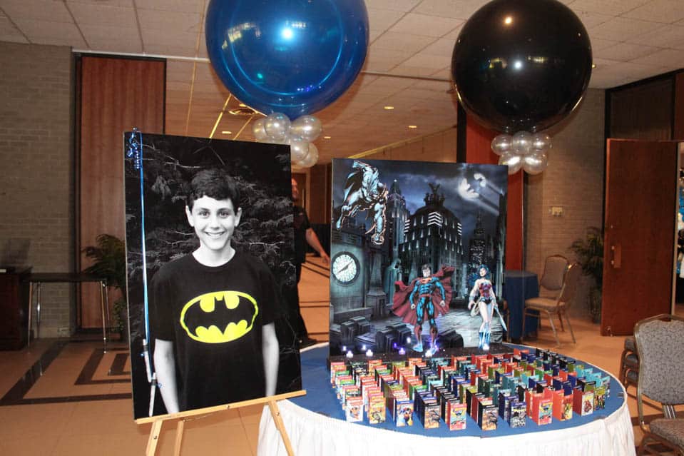 Comic Book Themed Seating Card Display with Gotham City Background and Photo Cutouts