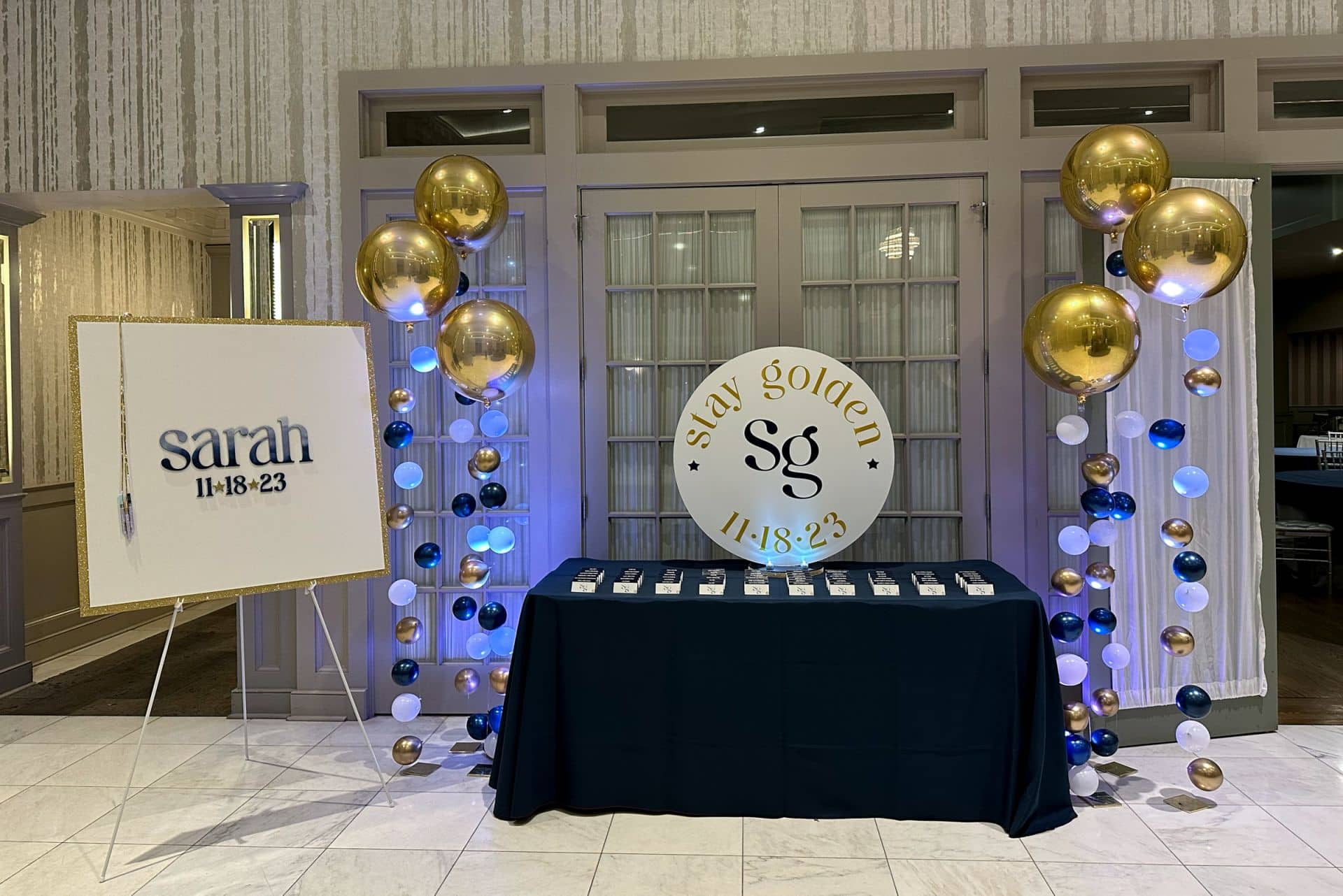 Gold and Navy Bat Mitzvah Entrance Display with Custom Logo Cutout, Sign in Board and LED Bubble Balloons at Mulino's at Lake Isle