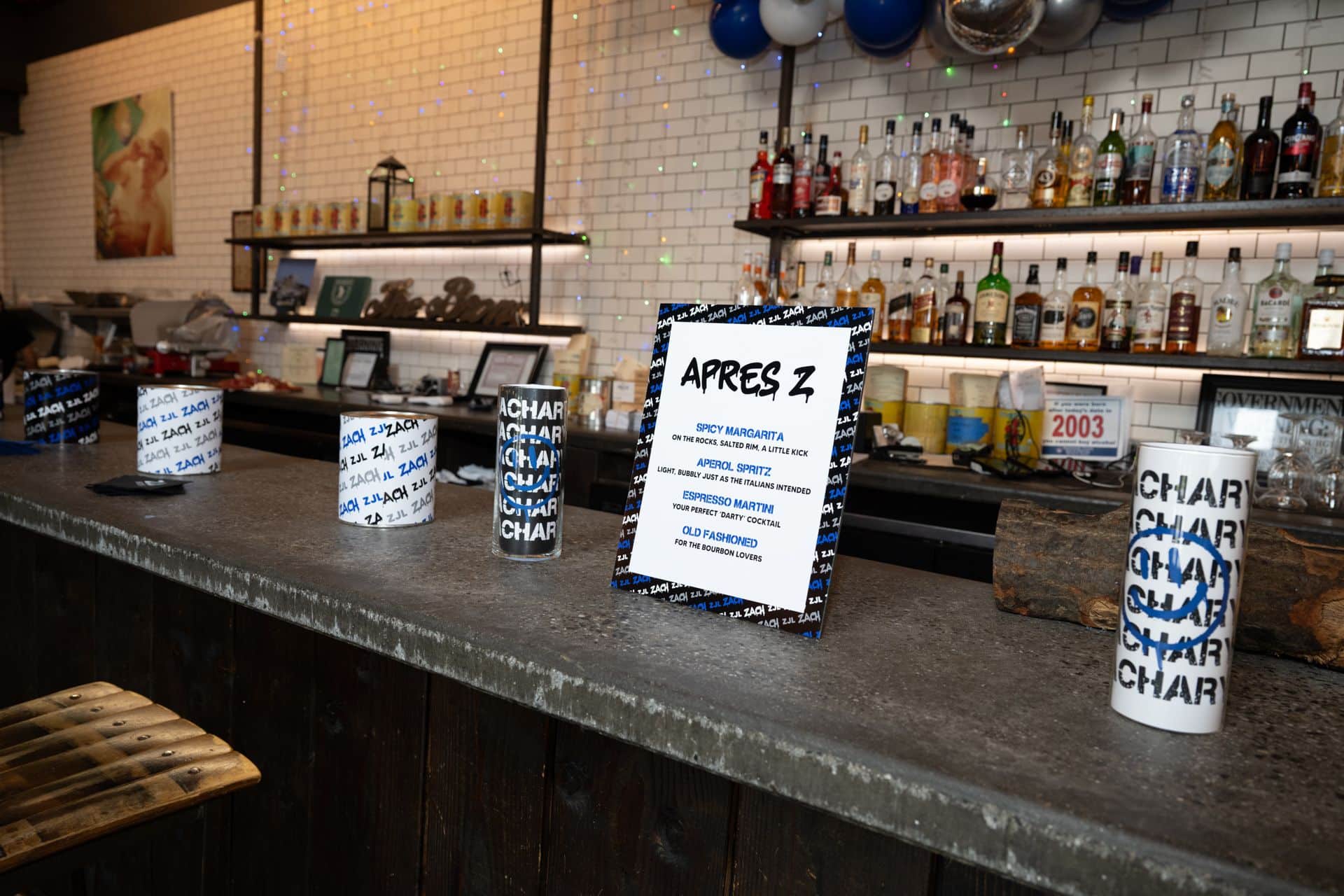 Signature Drink Sign for a Graffiti Theme Bar Mitzvah next to Custom Logo Wrapped Cylinders