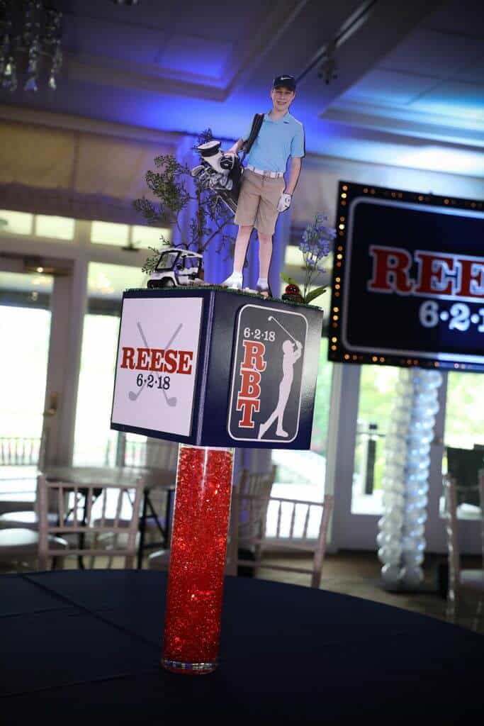 Golf Themed Cube Centerpiece with Custom Logos and Cutout Toppers on LED Base