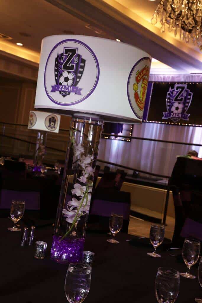 Soccer Themed Lampshade Centerpiece with Team Logos and LED Cylinders and Orchids