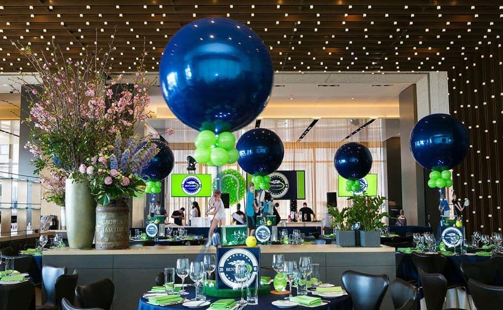 Tennis Themed Centerpiece with Cutout Photos and Navy and Lime Balloons at Riverpark, NYC