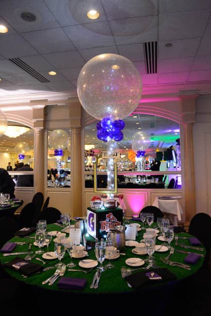 Football Themed Centerpiece with Sports Equipment and Turf Base