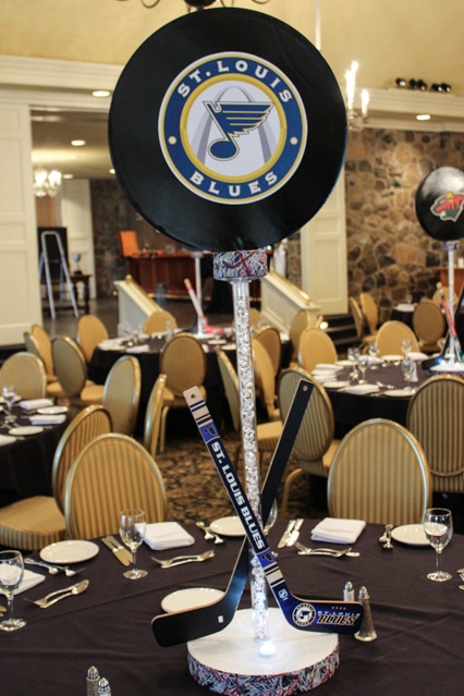 Hockey Puck Centerpiece with Team Logos and Criss Crossing Hockey Sticks