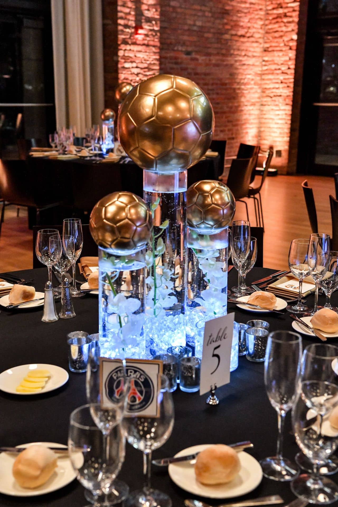 Gold Soccer Balls on Cylinders with Orchids and Chips