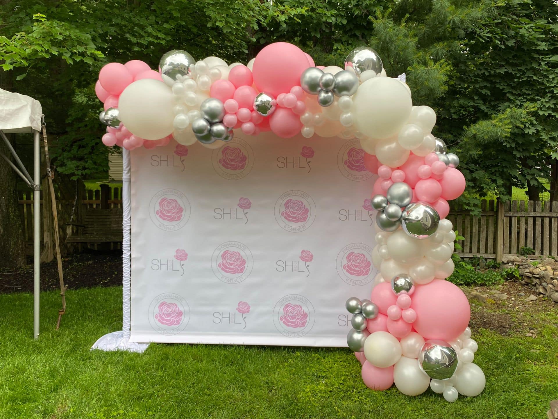 Amazing Custom Step and Repeat with Two Variation of Logos and Beautiful Pink and White Half Organic Arch