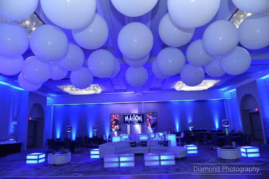 Royal Blue Uplighting with White Ceiling Balloon Treatment and Custom Logo Backdrop at the Marriott Park Ridge