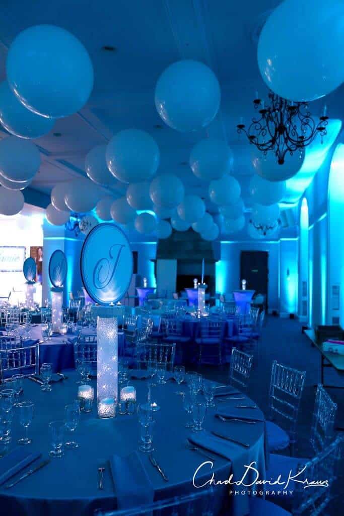 Turquoise Uplighting with LED Logo Centerpieces and Giant White Ceiling Balloons at Temple Shaaray Tefila, Bedford